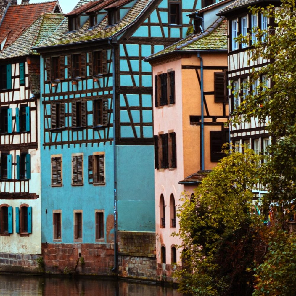 A vertical shot of vintage small houses along the river in the Petite-France region of Strasbourg